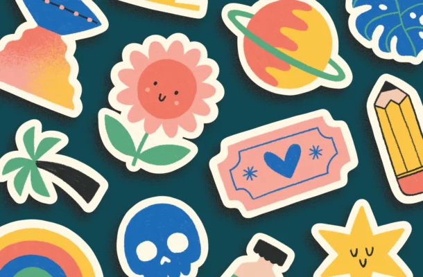 Cute stickers flatlayed on a dark background.