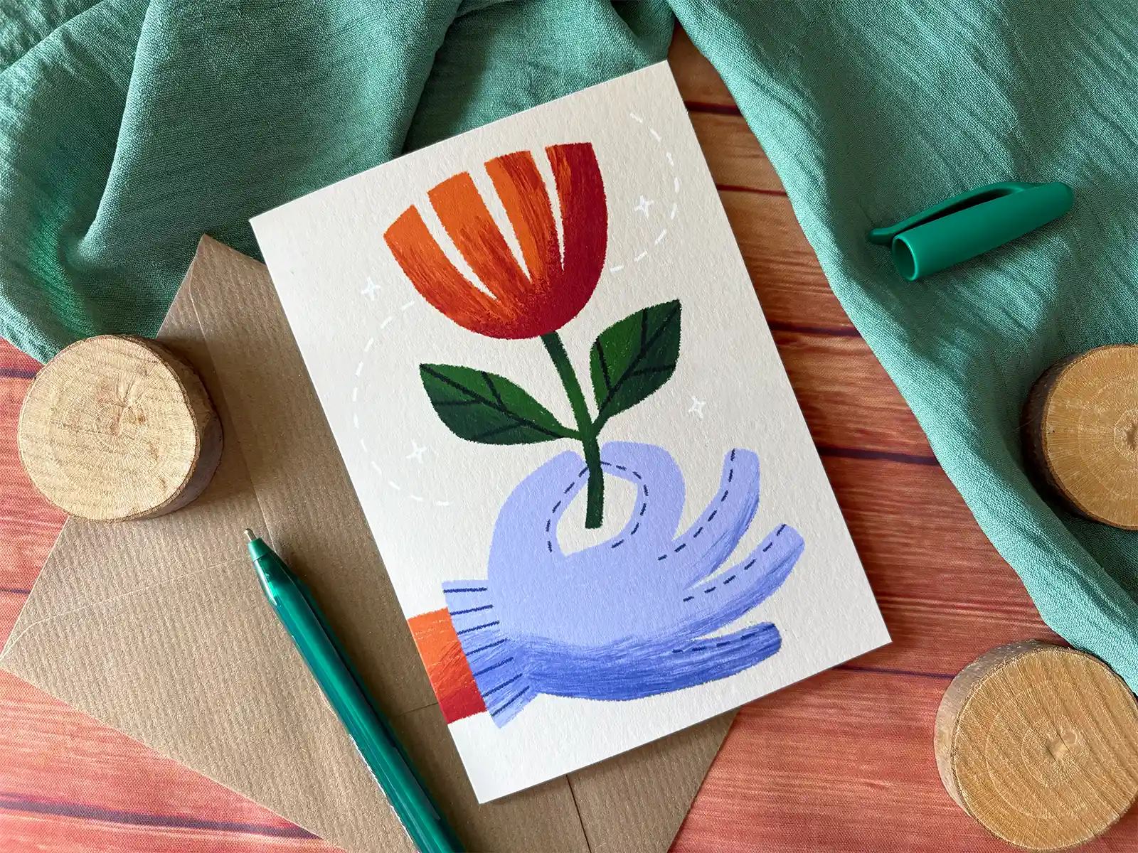 The Gardener greetings card, featuring a gloved hand offering a flower.