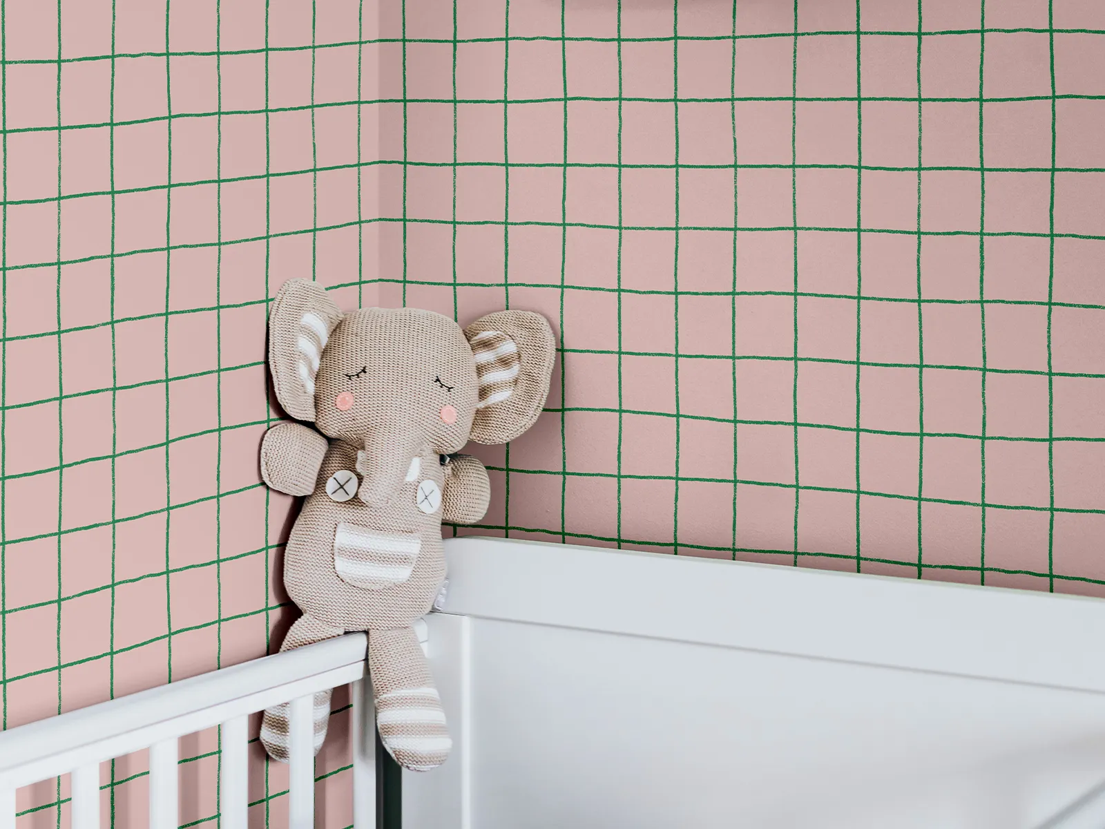 Pink grid pattern as wallpaper in a nursery