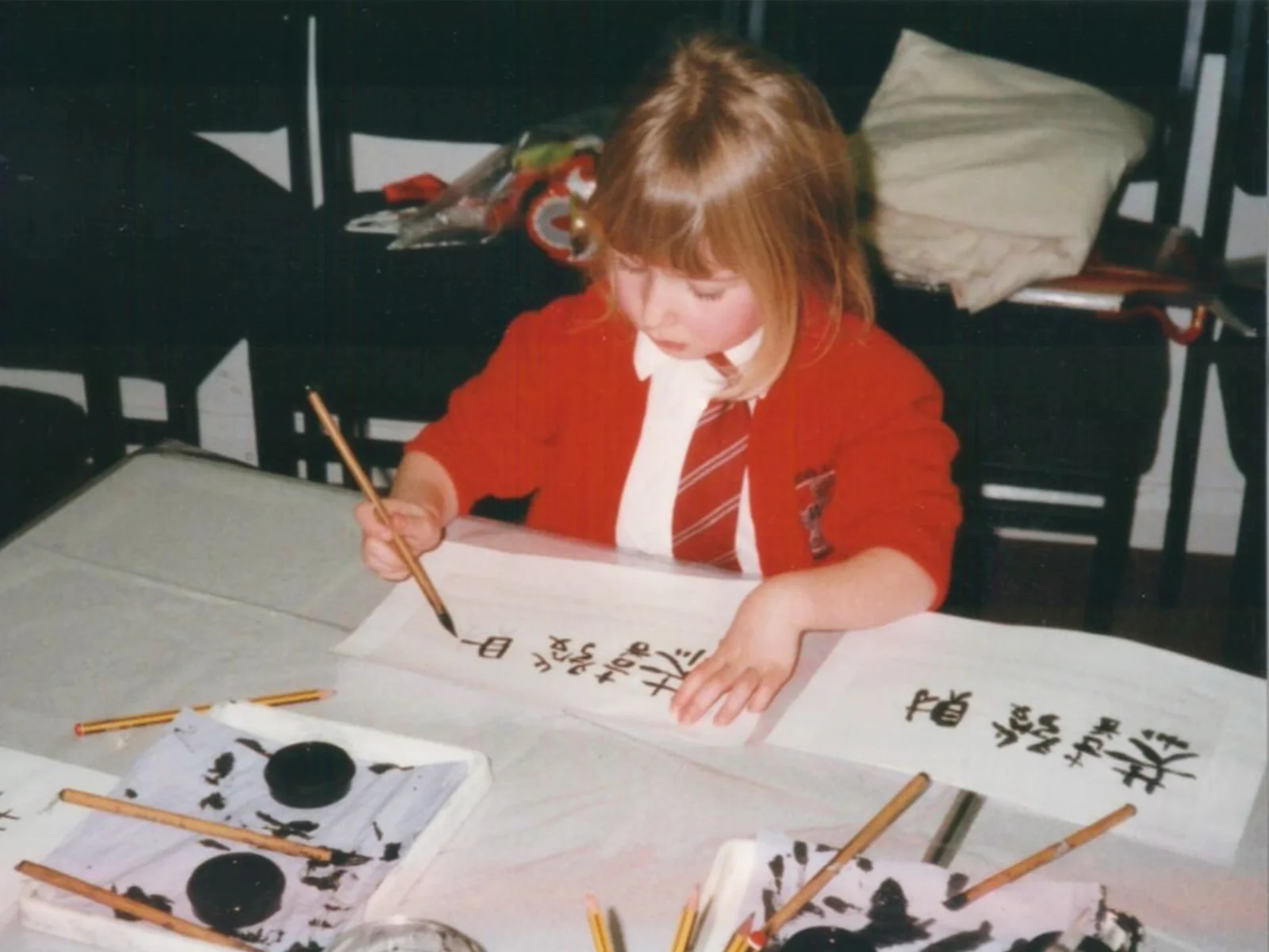 A young Clare working on a school project.