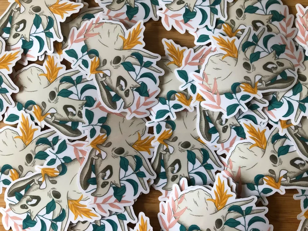 Lots of triceratops skull stickers laid out